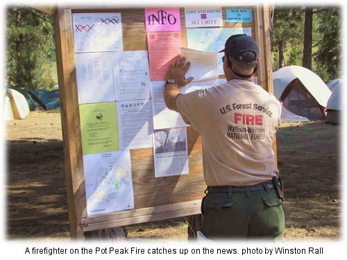 Firefighter from the Wallowa-Whitman checks out the info board